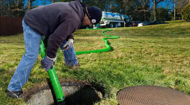 Service technician performing residential septic pumping and drainage maintenance in Albany, NY